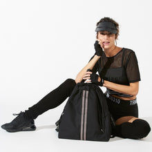 Load image into Gallery viewer, Woman carrying a ACE Bagpack color Black made with ECONYL® regenerated nylon
