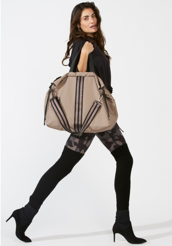 Woman carrying a ACE Tote Bag color Taupe made with ECONYL® regenerated nylon