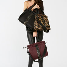 Load image into Gallery viewer, Woman carrying a ACE Urban Tote Bag color Black Leopard Burgundy made with ECONYL® regenerated nylon
