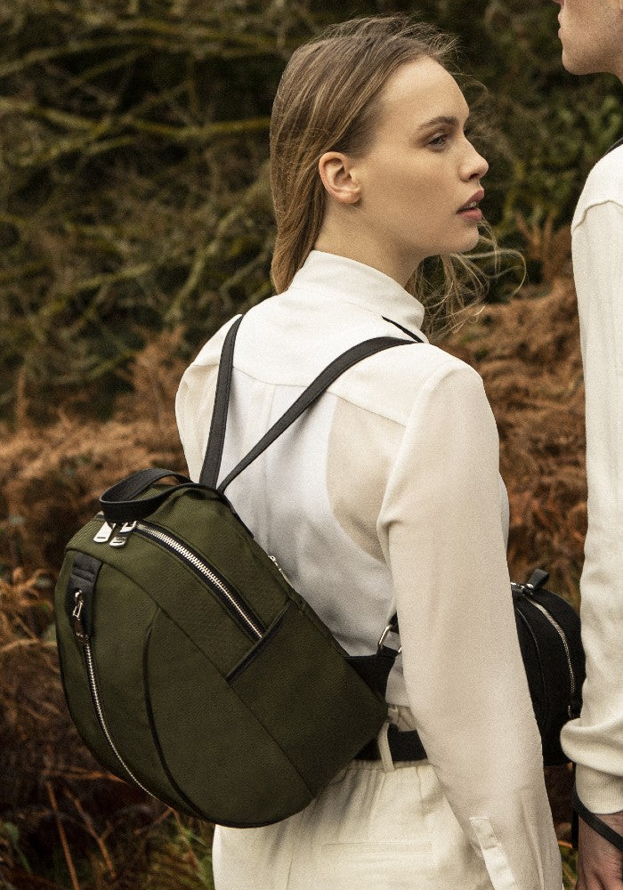 Woman carrying The Gallery Backpack Petite aoife® color Military green made with ECONYL® regenerated nylon
