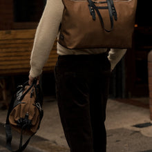 Load image into Gallery viewer, Detail of a man carrying The Gallery Tote To Backpack aoife® color Brown made with ECONYL® regenerated nylon
