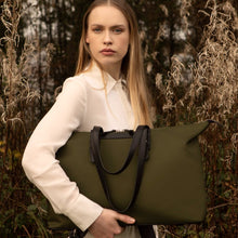 Load image into Gallery viewer, Woman carrying The Gallery Tote To Backpack aoife® color Military green made with ECONYL® regenerated nylon

