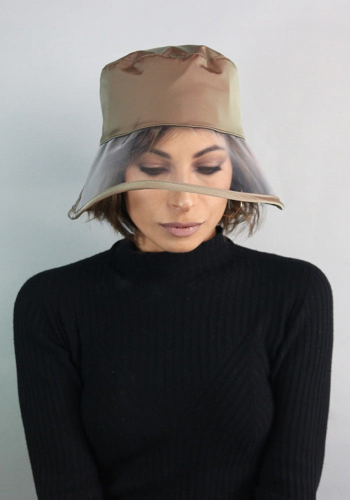 Woman wearing Bau, the waterproof bucket hat by Complit color Green Sage made with ECONYL® regenerated nylon