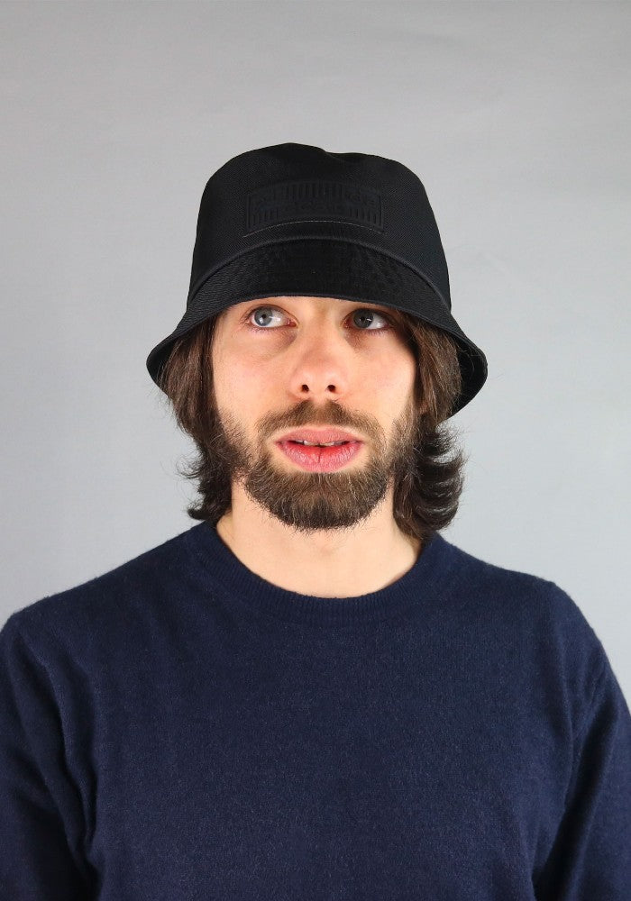 Man wearing Ecobucky, the waterproof bucket hat by Complit color Black made with ECONYL® regenerated nylon