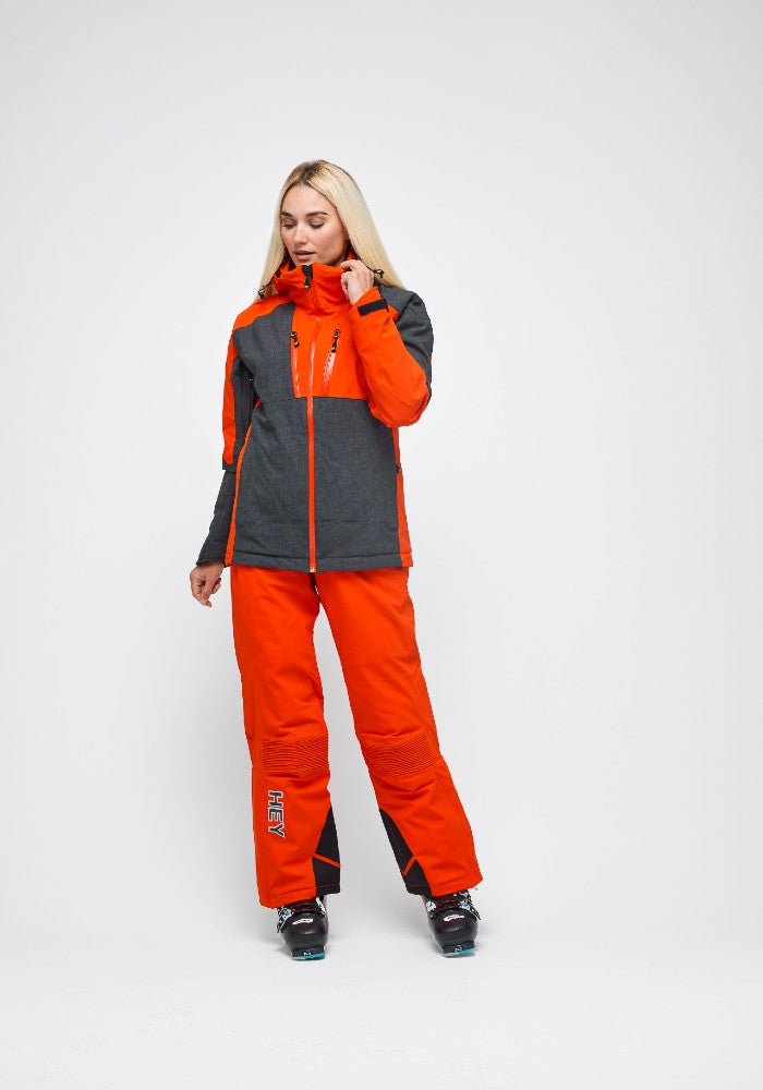 Woman wearing the Snowbird Wool Jacket Woman Hey Sport color Grey and Orange made with ECONYL® regenerated nylon