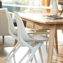 Load image into Gallery viewer, noho move™ chair by noho color white made with ECONYL® regenerated nylon in a dining room
