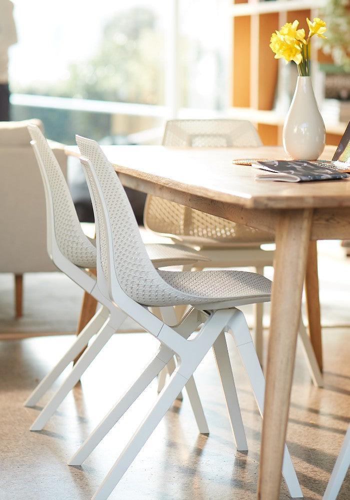 noho move™ chair by noho color white made with ECONYL® regenerated nylon in a dining room