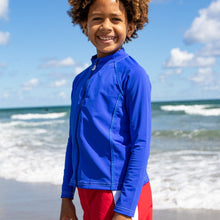 Load image into Gallery viewer, Boy wearing the NoNetz NoRash Guard for Kids color Blue made with ECONYL® regenerated nylon
