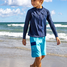 Load image into Gallery viewer, Boy wearing the NoNetz NoRash Guard for Kids color Navy made with ECONYL® regenerated nylon

