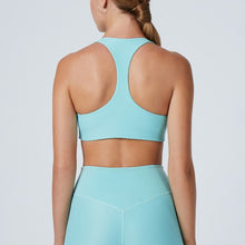 Load image into Gallery viewer, Back view of a woman wearing the Alva Sports Bra Arctic by Outfyt color Pale Blue made with ECONYL® regenerated nylon
