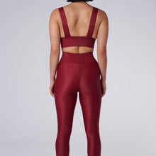 Load image into Gallery viewer, Back view of a woman wearing the Cora Leggings Wine by Outfyt color Red made with ECONYL® regenerated nylon
