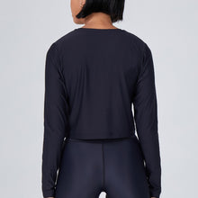 Load image into Gallery viewer, Back view of a woman wearing the Elin Long Sleeve Crop by Outfyt color Black made with ECONYL® regenerated nylon
