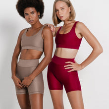 Load image into Gallery viewer, Women wearing the Mera Sports Bra Wine by Outfyt color Red made with ECONYL® regenerated nylon
