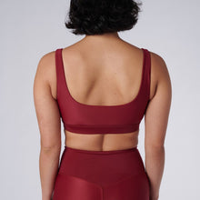 Load image into Gallery viewer, Back view of a woman wearing the Mera Sports Bra Wine by Outfyt color Red made with ECONYL® regenerated nylon
