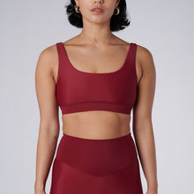 Load image into Gallery viewer, Front view of a woman wearing the Mera Sports Bra Wine by Outfyt color Red made with ECONYL® regenerated nylon
