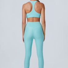 Load image into Gallery viewer, Back view of a woman wearing the Mila Leggings Arctic by Outfyt color Pale Blue made with ECONYL® regenerated nylon
