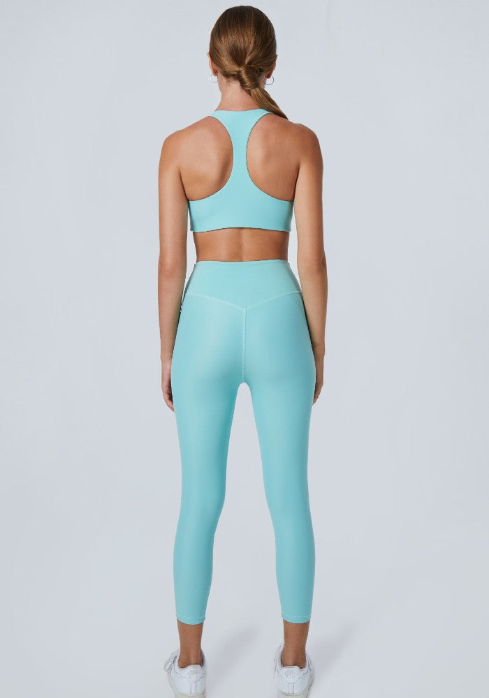 Back view of a woman wearing the Mila Leggings Arctic by Outfyt color Pale Blue made with ECONYL® regenerated nylon
