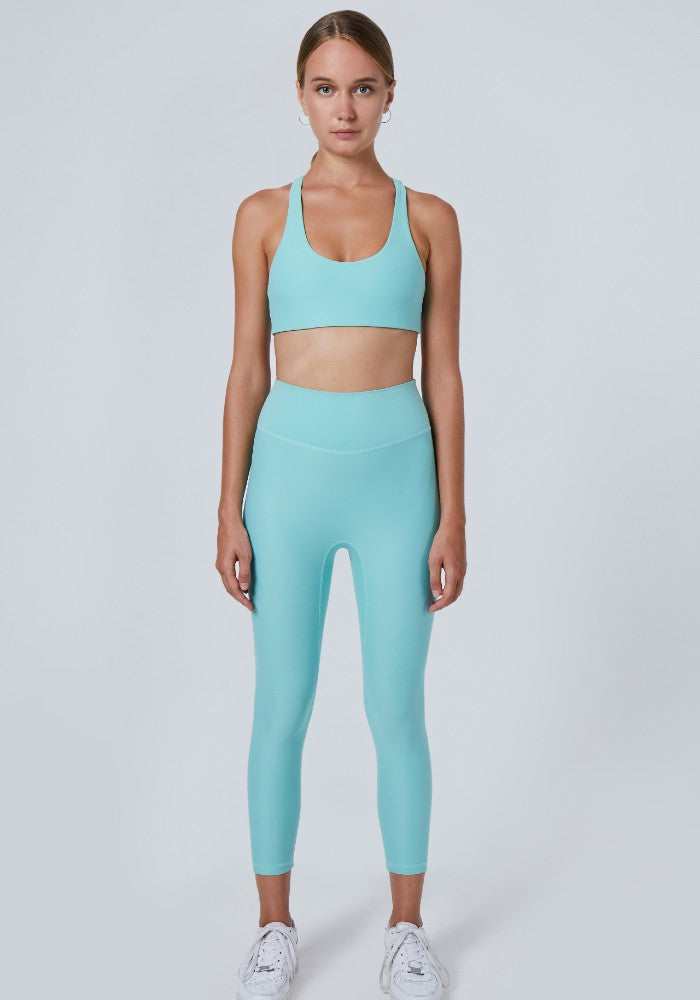 Front view of a woman wearing the Mila Leggings Arctic by Outfyt color Pale Blue made with ECONYL® regenerated nylon