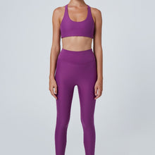 Load image into Gallery viewer, Front view of a woman wearing the Mila Leggings Plum by Outfyt color Purple made with ECONYL® regenerated nylon
