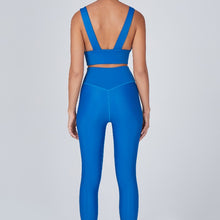 Load image into Gallery viewer, Back view of a woman wearing the Sage Leggings Aegean by Outfyt color Blue made with ECONYL® regenerated nylon
