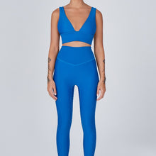 Load image into Gallery viewer, Front view of a woman wearing the Sage Leggings Aegean by Outfyt color Blue made with ECONYL® regenerated nylon
