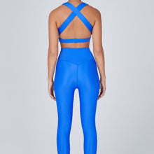 Load image into Gallery viewer, Back view of a woman wearing the Sage Leggings Lapis by Outfyt color Blue made with ECONYL® regenerated nylon
