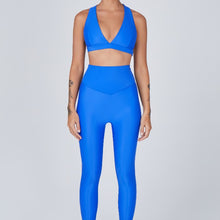 Load image into Gallery viewer, Front view of a woman wearing the Sage Leggings Lapis by Outfyt color Blue made with ECONYL® regenerated nylon
