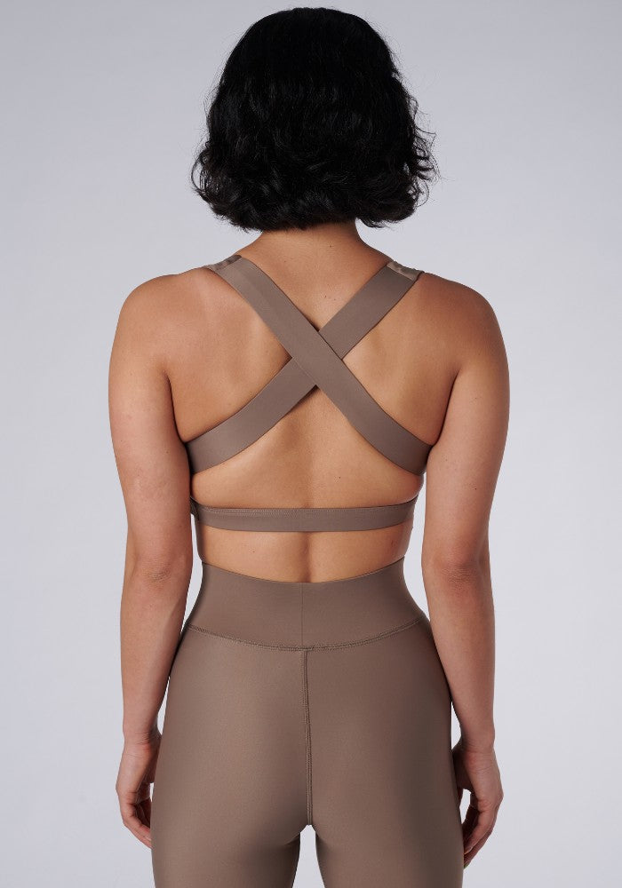 Back view of a woman wearing the Lilly V 2.0 Sand by Outfyt color Beige made with ECONYL® regenerated nylon