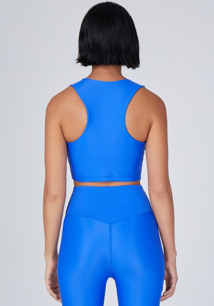 Back view of a woman wearing the Tula Crop Top Lapis by Outfyt color Blue made with ECONYL® regenerated nylon