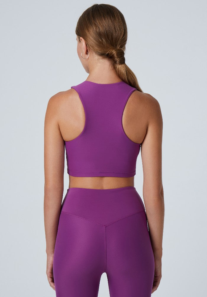 Back view of a woman wearing the Tula Crop Top Plum by Outfyt color Purple made with ECONYL® regenerated nylon