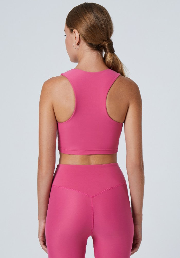 Back view of a woman wearing the Tula Crop Top Rose by Outfyt color Pink made with ECONYL® regenerated nylon