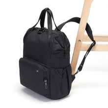 Load image into Gallery viewer, Side view of the Pacsafe Citysafe CX Anti-Theft Backpack color Black made with ECONYL® regenerated nylon locked to a chair
