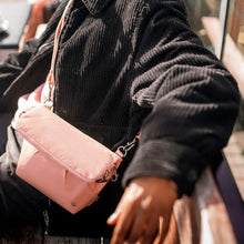 Load image into Gallery viewer, Everyday with the Pacsafe Citysafe CX Anti-Theft Convertible Crossbody color Rose made with ECONYL® regenerated nylon
