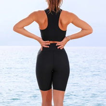 Load image into Gallery viewer, Woman wearing the Comfy Short by Seawild color Black made with ECONYL® regenerated nylon
