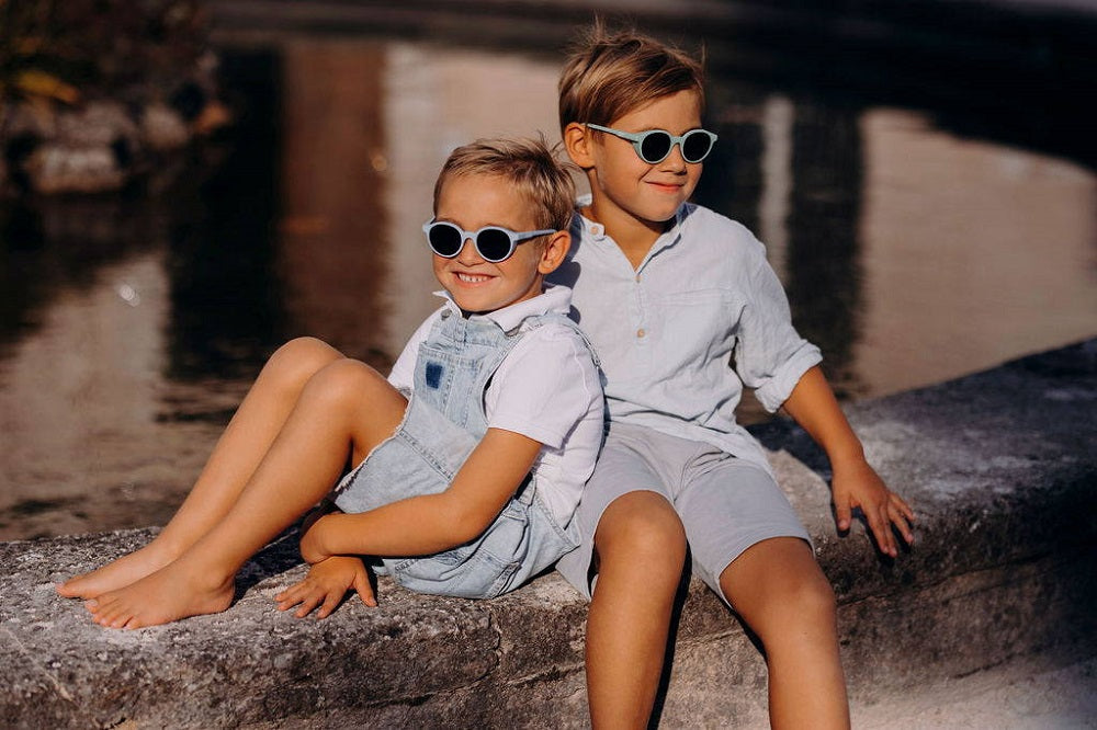 Young boys wearing SooNice Children Sunnies by SooNice color ice blue made with ECONYL® regenerated nylon