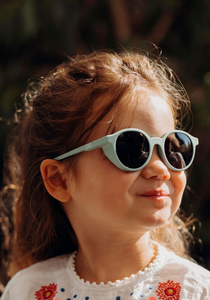 Young girl wearing SooNice Children Sunnies by SooNice color mint green made with ECONYL® regenerated nylon