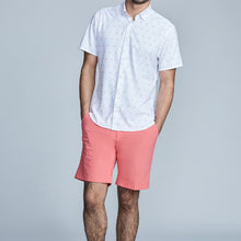Load image into Gallery viewer, Man wearing The Triton Short Pant State Of Matter color Canyon Rose made with ECONYL® regenerated nylon
